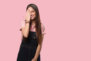 Young cool woman shouting happy and covering face with hand