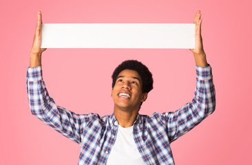 Advertisement. Student holding blank banner with copy space