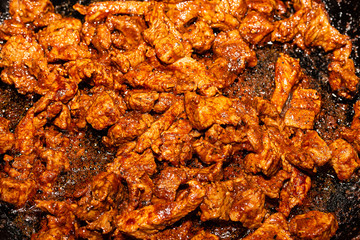 fried goulash aromatic delicious source of protein in a frying pan background culinary
