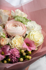 beautiful bouquet in hand, a piece of the bouquet, the work of the florist, live flowers