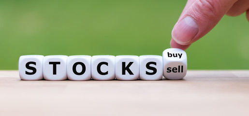Symbol for buying or selling stocks. Hand turns a dice and changes the word 