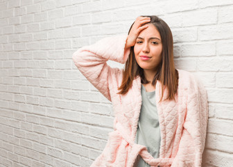 Young woman wearing pajama worried and overwhelmed