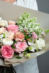 beautiful delicate bouquet in hand, a bouquet of fresh flowers, handicraft, the work of a florist