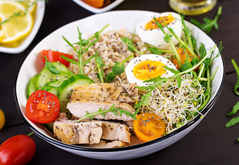 Fresh salad. Breakfast bowl with oatmeal, chicken fillet, tomato, lettuce, microgreens and boiled egg. Healthy food. Vegetarian buddha bowl.