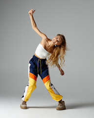 Hip hop dancer moving and jumping in studio