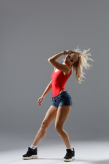 Hip hop dancer moving and jumping in studio