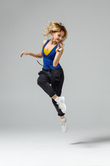 Hip hop dancer moving and jumping in studio
