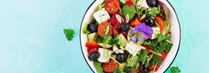 Fotobehang Greek salad  with cucumber, tomato, sweet pepper, lettuce, green onion, feta cheese and olives with olive oil. Healthy food. Top view © timolina