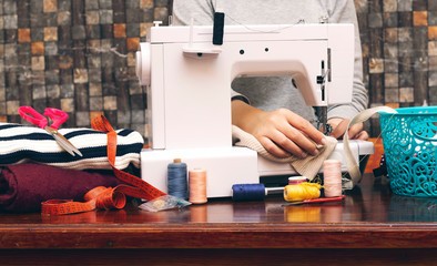 closeup women sewing on a machine