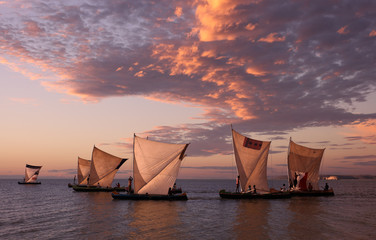 Traditional fishing pirogues with dramatic sky at sunset in Anakao, Madagascar - obrazy, fototapety, plakaty