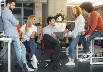 Creative team discussing new ideas in coworking space
