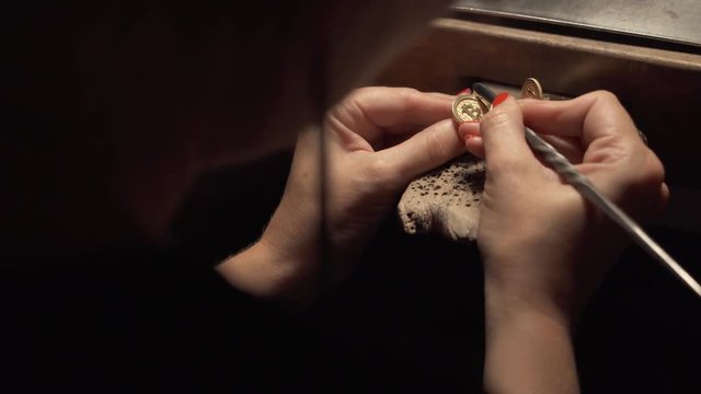 Female goldsmith crafting bitcoin lapel pin