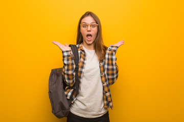 Young student woman surprised and shocked