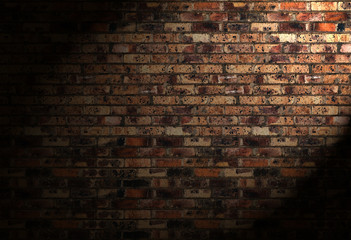 Old brick wall with shade of spot light . Horizontal wide brick wall background.