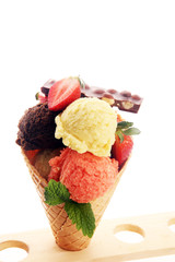 Set of ice cream scoops of different colors and flavours with berries and fruits