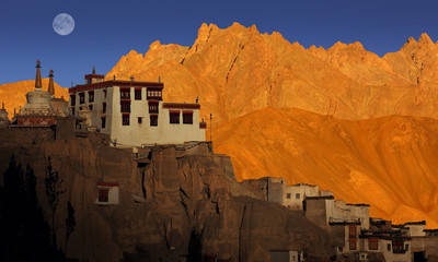 Lamayuru Buddhist monastery and scenic mountain view, sunset with full moon, Ladakh, India