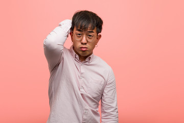 Young chinese man worried and overwhelmed