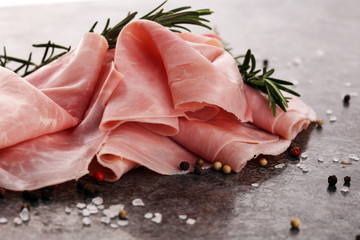 Sliced ham on wooden background. Fresh prosciutto cotto. Pork ham sliced.