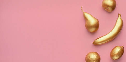 Golden fruits collage on pink