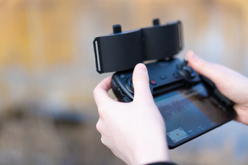 Remote control for quadrocopter, close-up. Man holding device