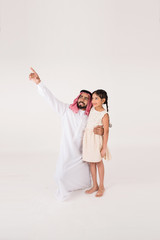 Arab father with his daoghter showing her something