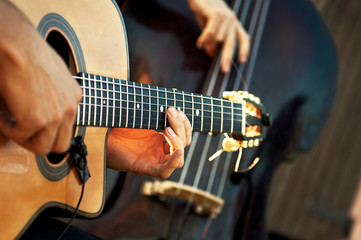 Acoustic guitar with double bass in acoustic group during a show
