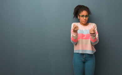 Young african american girl with blue eyes doing a gesture of need