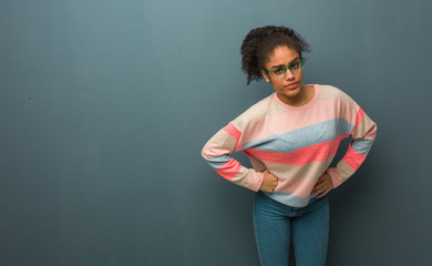 Young african american girl with blue eyes scolding someone very angry