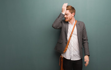 Young redhead business man forgetful, realize something