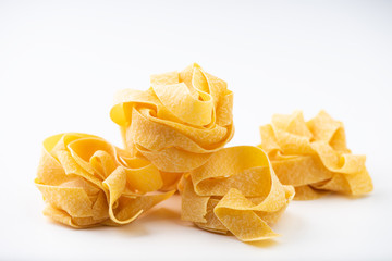 Raw pasta on white surface