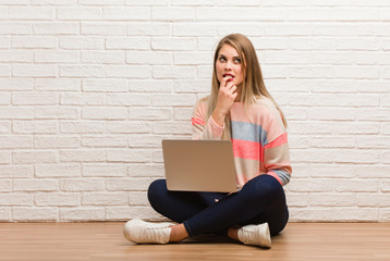 Young russian student woman sitting relaxed thinking about something looking at a copy space