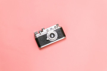 Old rangefinder camera on a pink background Vintage style