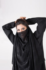 Beautiful Arab woman in traditional dress covering her face