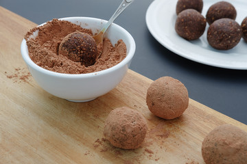 Making handmade chocolate truffles on wooden background - 261333649