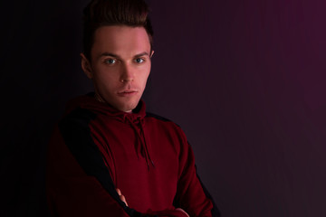 Fototapeta premium Portrait of a guy in a hooded sweater.