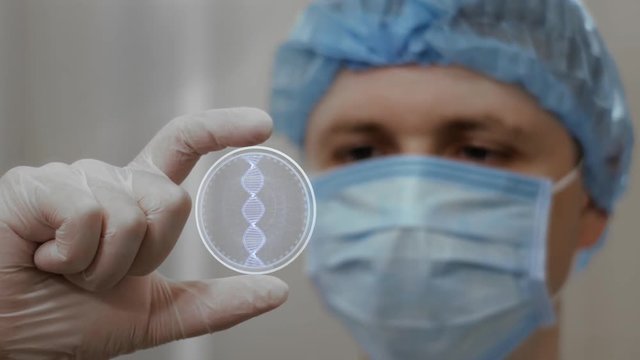 Doctor looks at innovative holographic projection with DNA. Male scientist in medical mask conducting technological research on hologram. Concept of futuristic medicine, device of future science