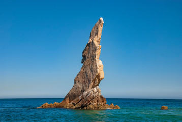 Fototapeta na wymiar Neptunes Finger is rock formation that is easy to spot along the cliffs outside the marina in Cabo San Lucas, Mexico