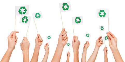 Hands holding paper flags with recycle symbol