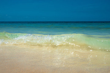 Fototapeta na wymiar Tropical summer sea wave, sand beach and sky