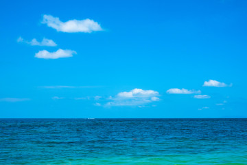 Fototapeta na wymiar Calm flat surface of sea and cloudless clear blue sky at horizon.