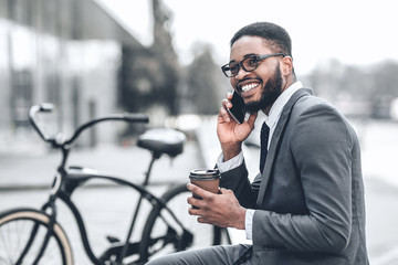 No time for break. Millennial businessman talking on phone