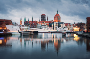 Old town of Gdansk at night. City reflections in Motlava river.
