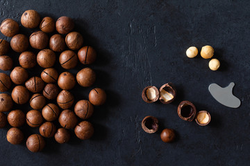 Top view of background texture of fresh natural unshelled raw macadamia nuts, full frame and flat lay