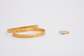 gold bangles and gold ring isolated on white background