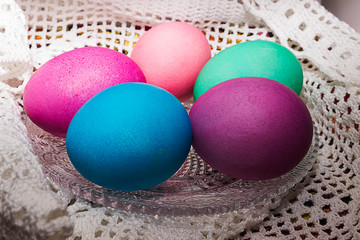 Fototapeta na wymiar Colored Easter eggs on a white lace napkin