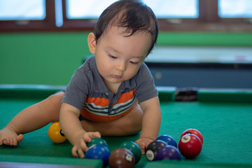 Baby boy playing snooker