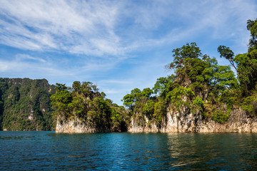 Beautiful nature rock mountains cliff and blue emerald water color lake river with blue clear sky in Ratchaprapa Dam at Khao Sok National Park, Surat Thani Province, Thailand. Asia tourism location.