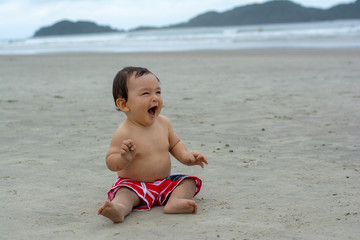 Fototapeta na wymiar Baby boy in the beach fun traveling with kids funny smile