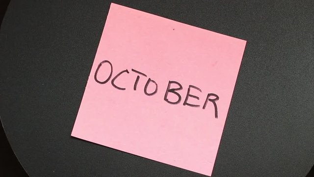 An inscription october on a sticker that is spinning
