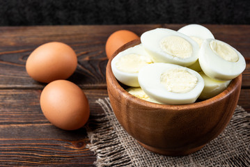 Boiled eggs on dark wooden background.